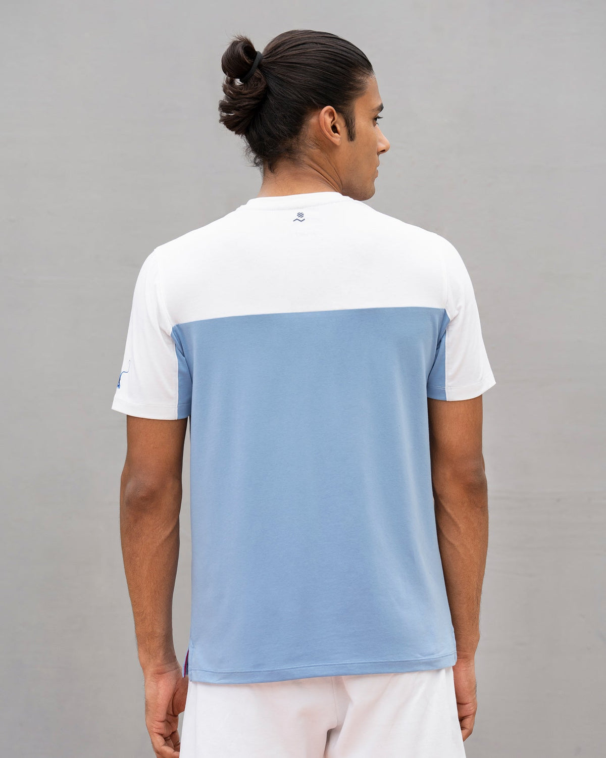 Back of an Everyday Crew Neck T-shirt in white and blue worn by a person.