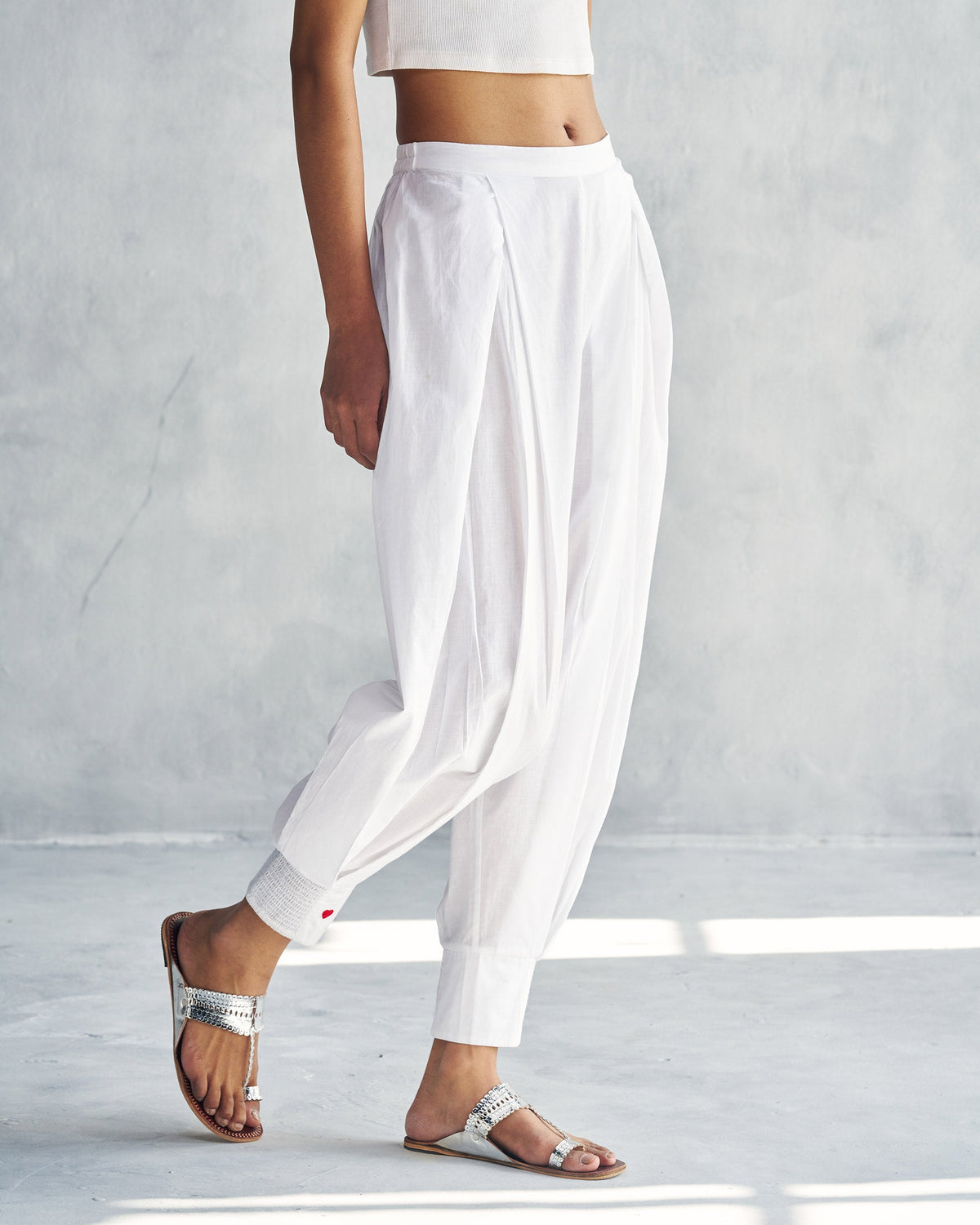 Side view of white Puff Pants worn by a person.