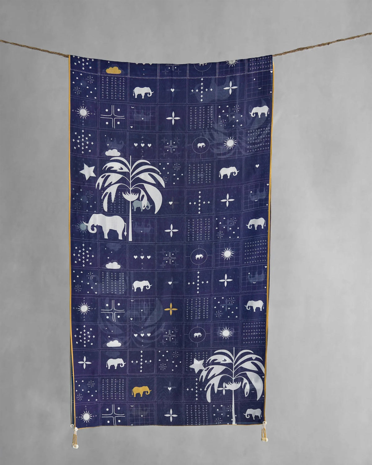 Navy Parken scarf hung flat, showing elephant and palm tree motifs.