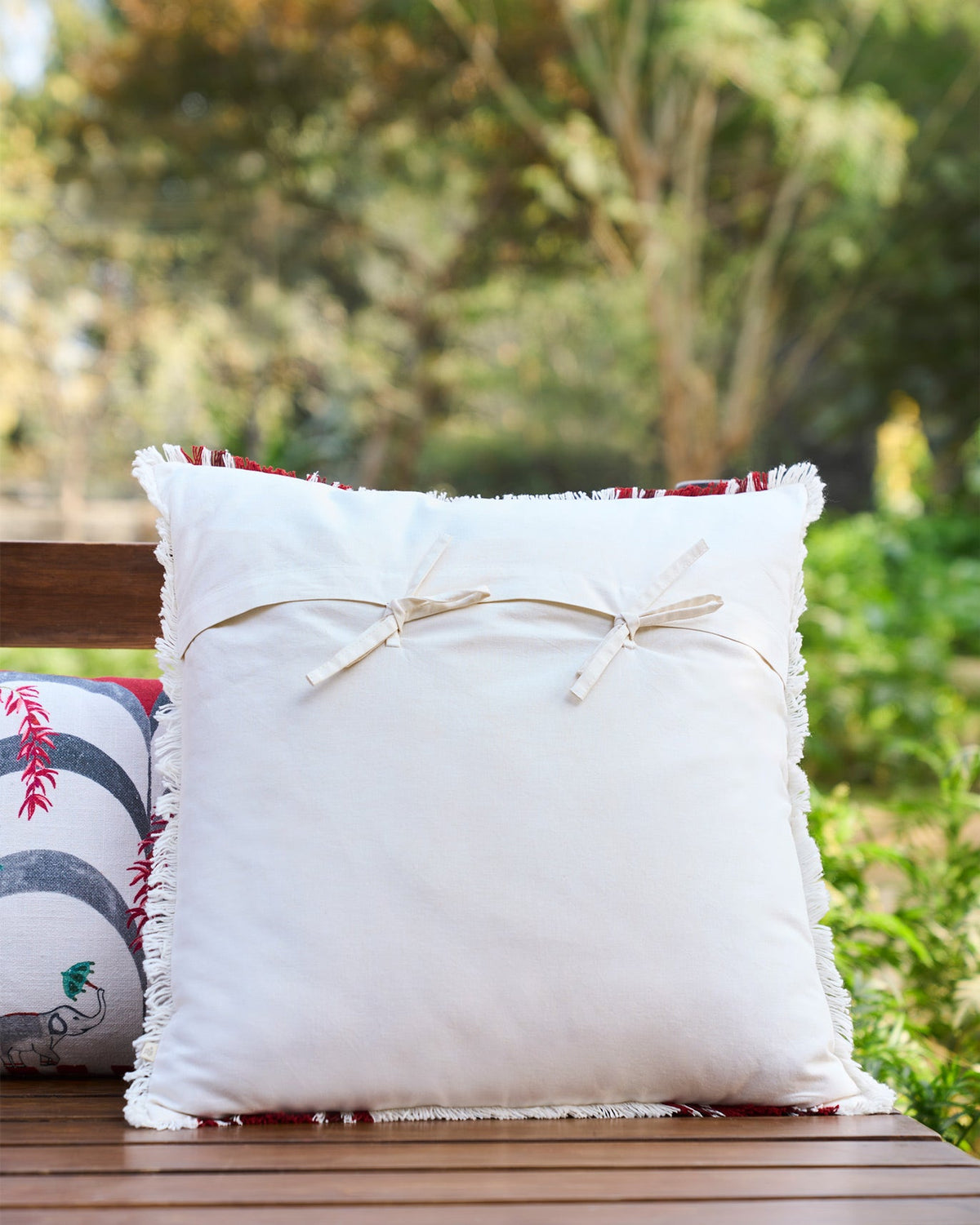 Back of the Cara Cushion Cover showing two cream tie ribbons.