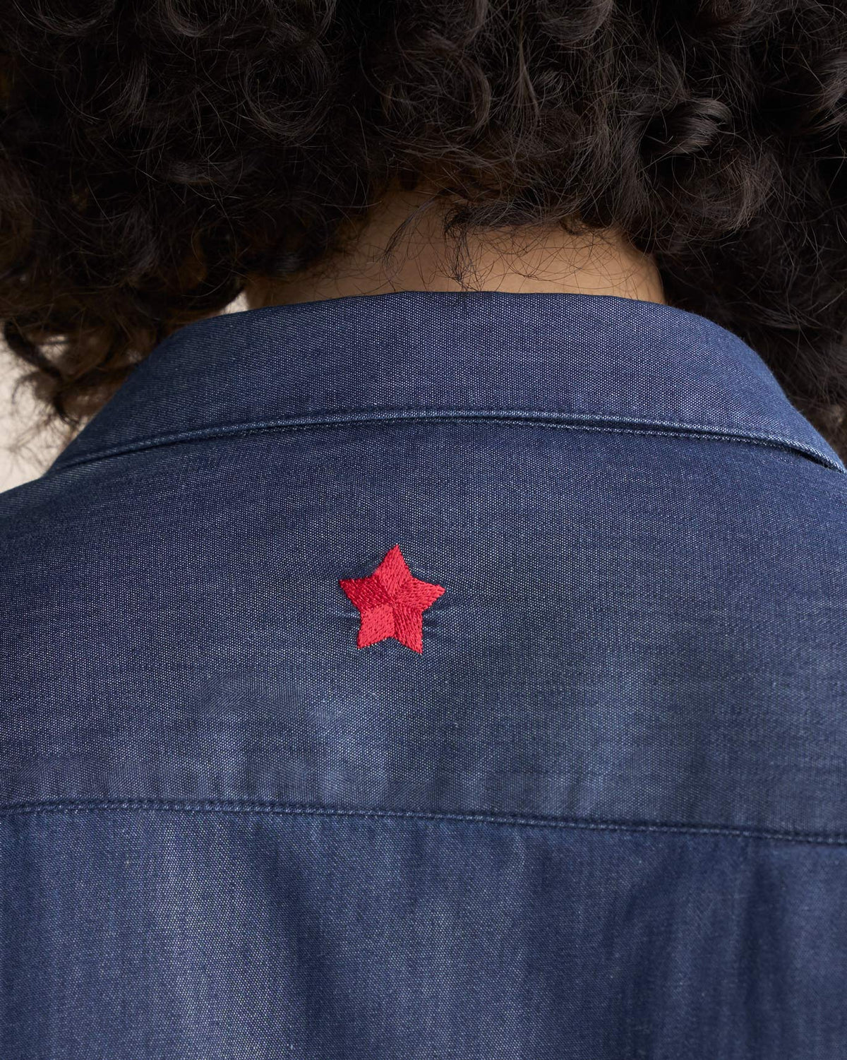 Close-up of the Drop Armhole Shirt back collar showing a red star embroidery.