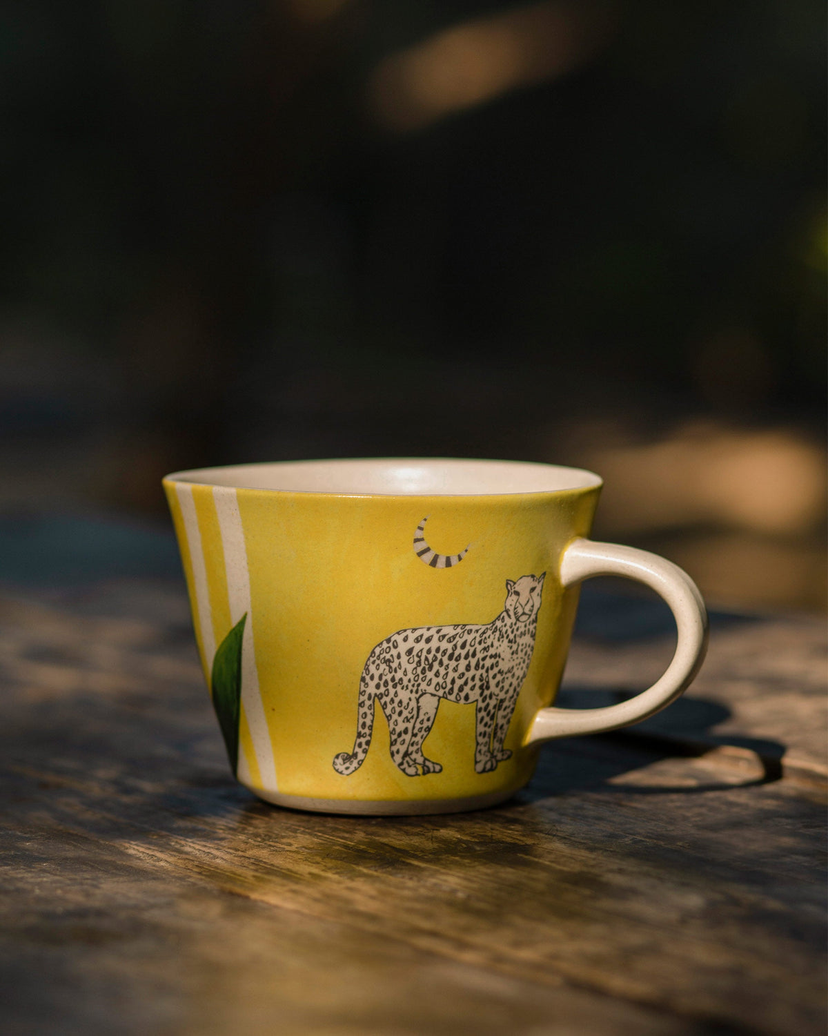 Leopard Soup Mug in yellow with a leopard motif and a leaf, handle on the right.