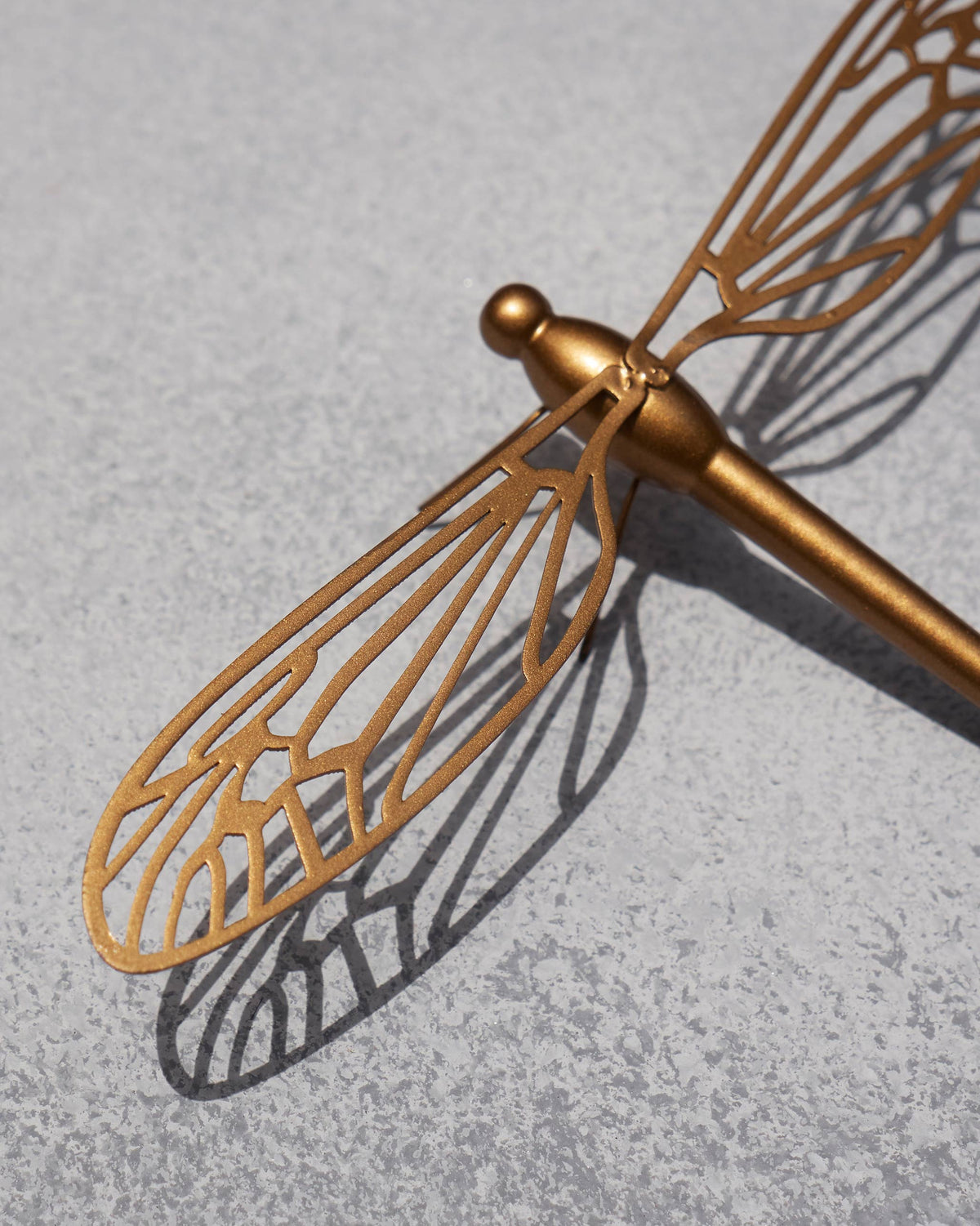 Close-up of a Dragonfly accent piece showing a gold cut-out wing.