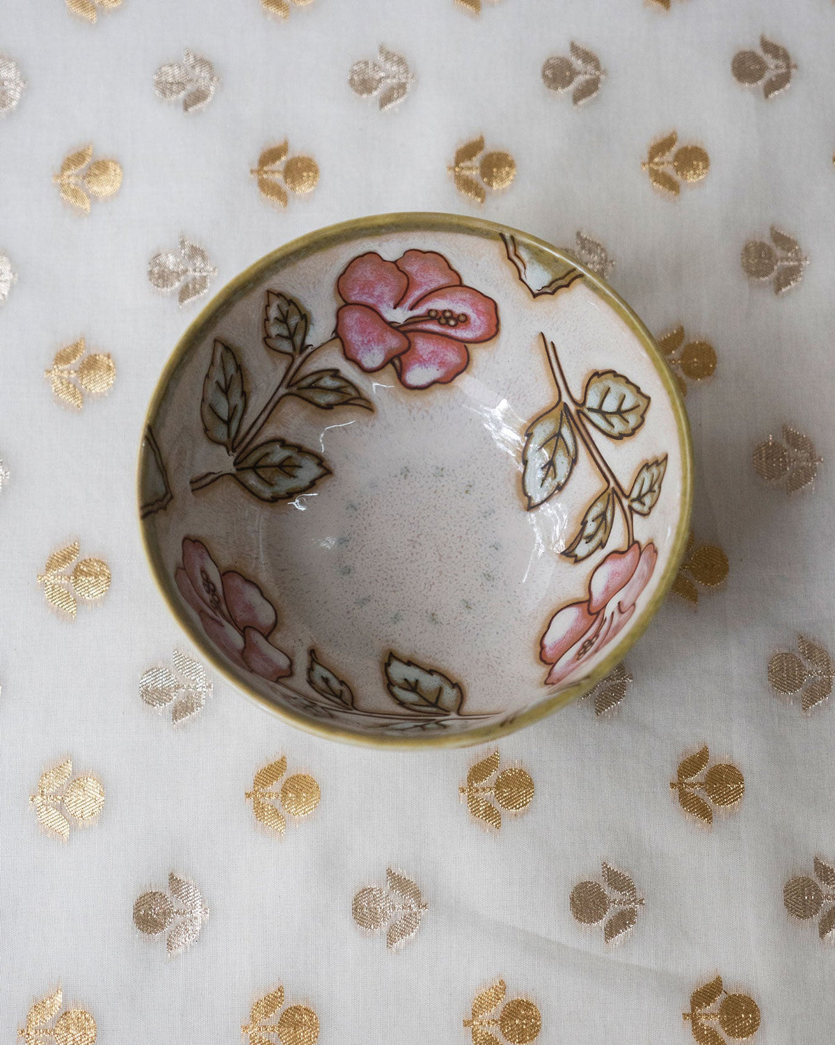 Overhead view of Zanzibar Katori with pink flowers around its inner wall.