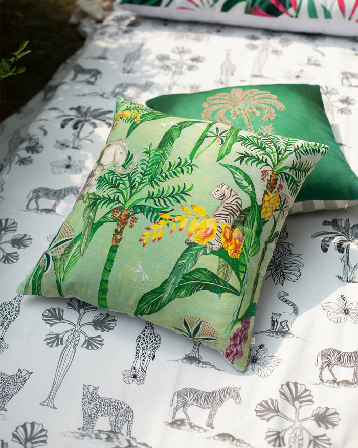 Idukki Cushion Cover with a green jungle print of palms and a tiger.