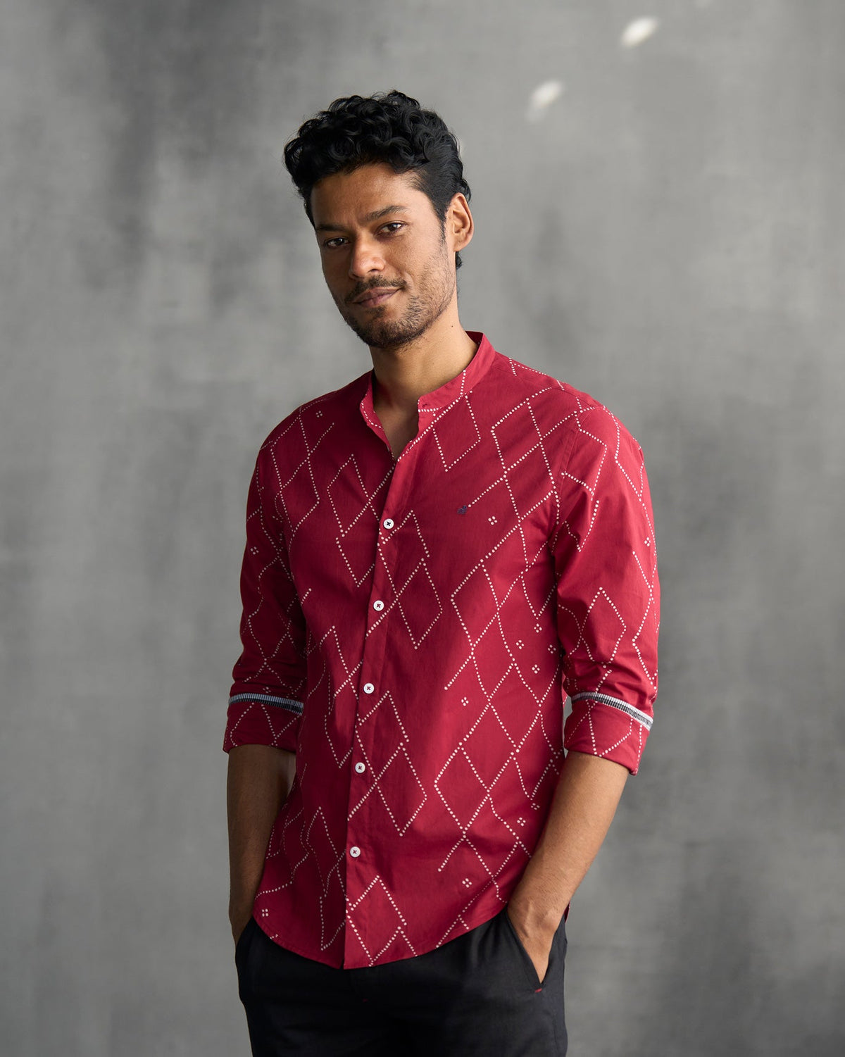 Person wearing a red Nawab shirt with grey-striped cuff linings.
