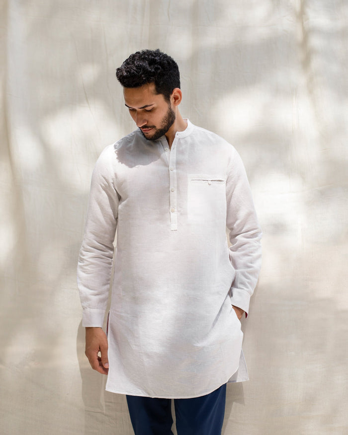 Person wearing the Pondicherry Kurta in white with a chest pocket.