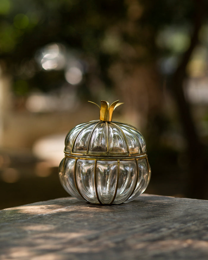 Anar Deco Jar, a ribbed glass jar with a brass leaf on its lid.