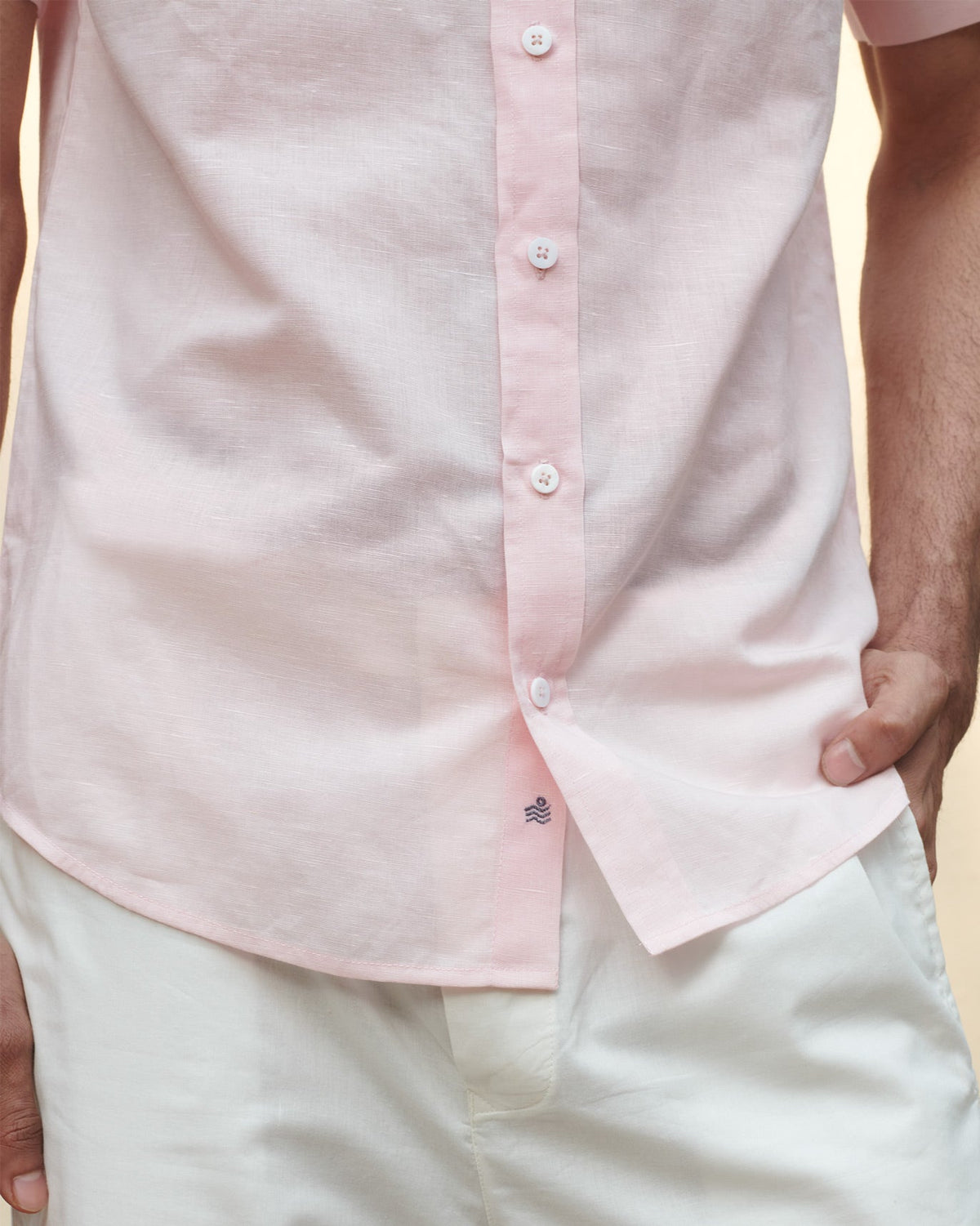 Close-up of a pink Half Sleeve Shirt showing white buttons and a small navy logo.