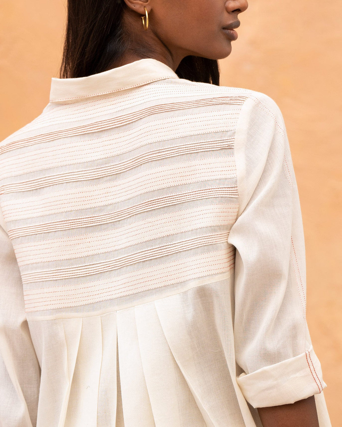 Close-up of the Back Flayer Top back yoke showing horizontal pintucks and pleats.