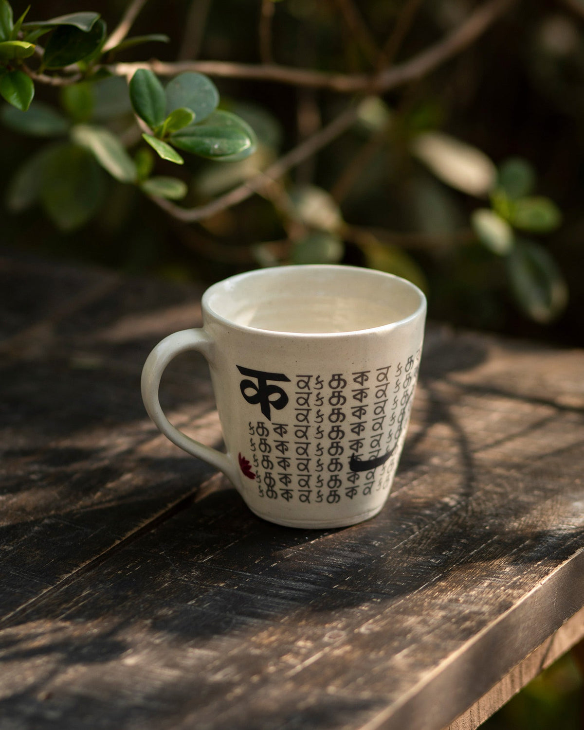 Side view of Alphabet K Mug with rows of small lettering on the other side.