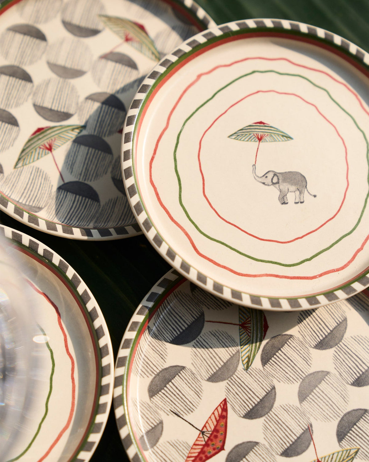 Close-up of a Tribe Coaster with an elephant under a red umbrella.