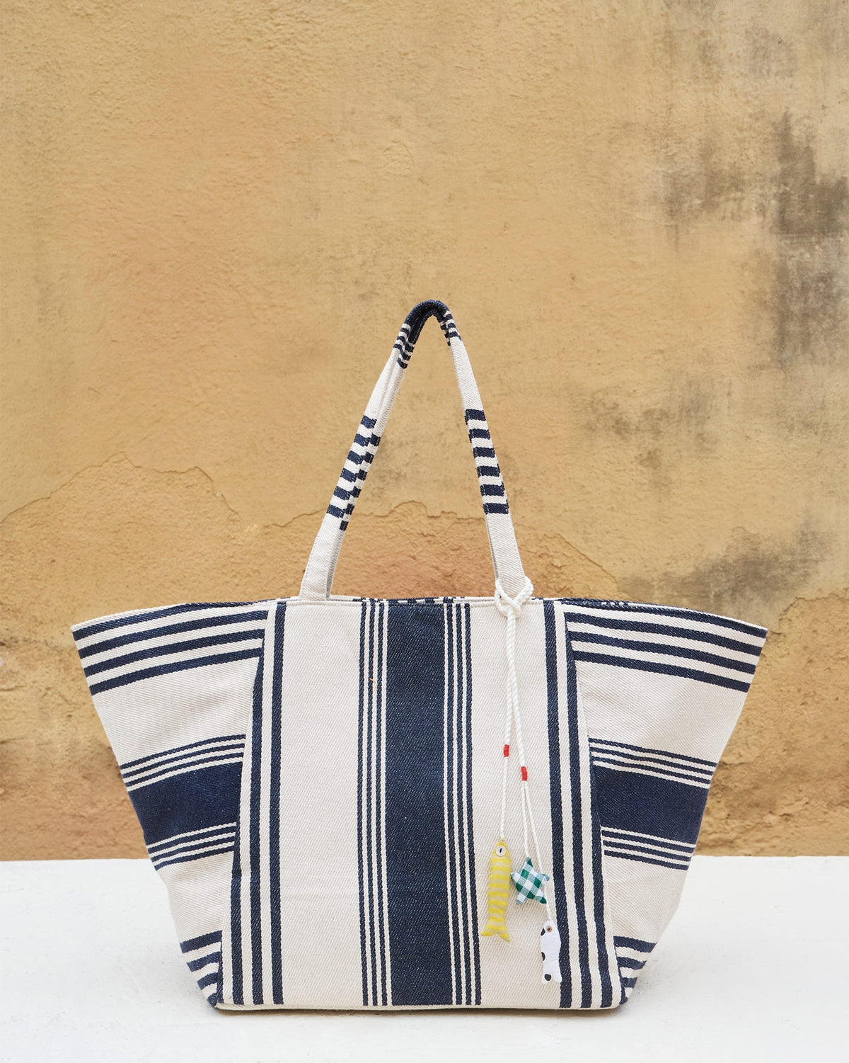 Serenity Tote standing upright, showing its navy and ivory stripes.