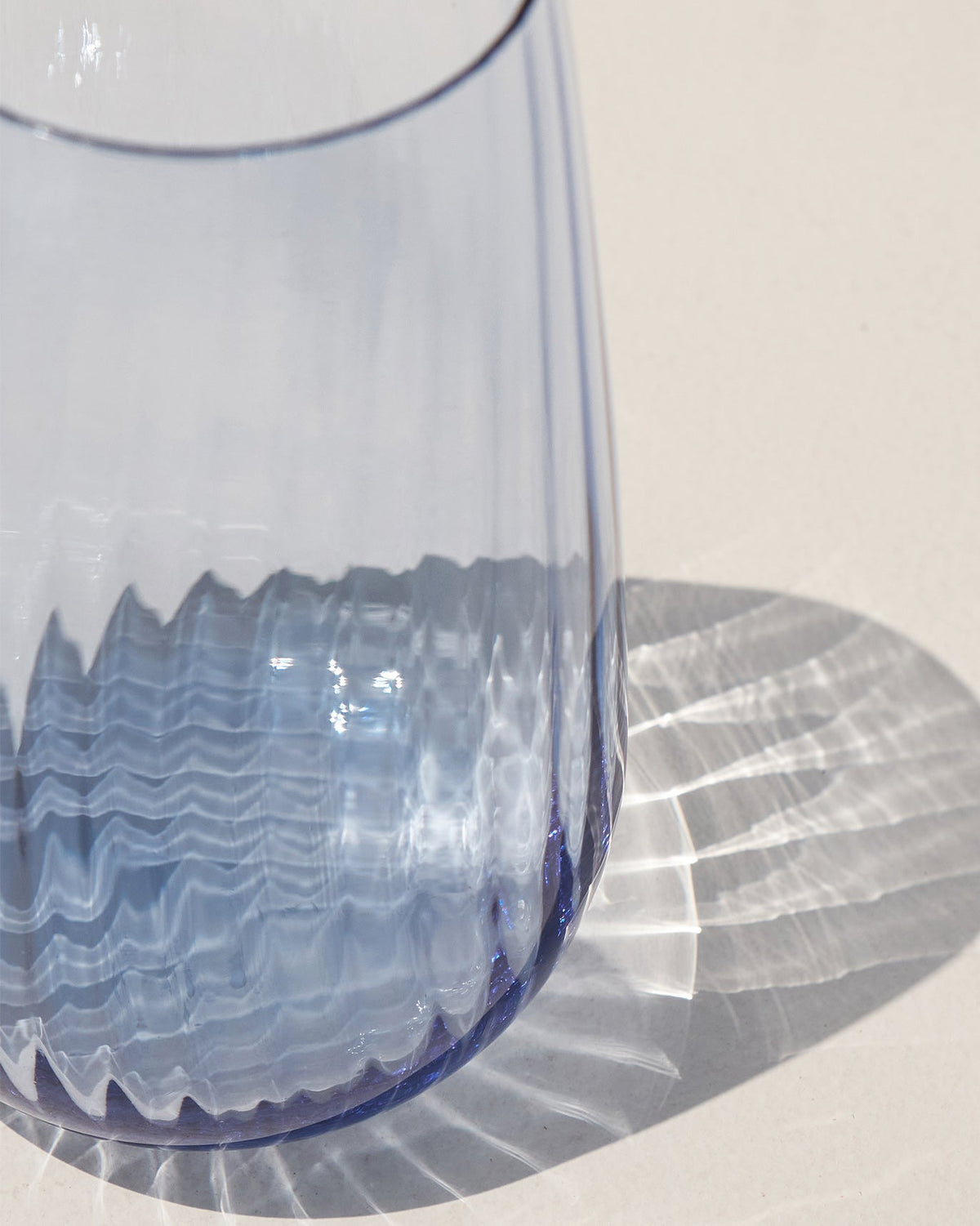 Close-up of Harmony Highball Glass in blue showing the ribbed base.