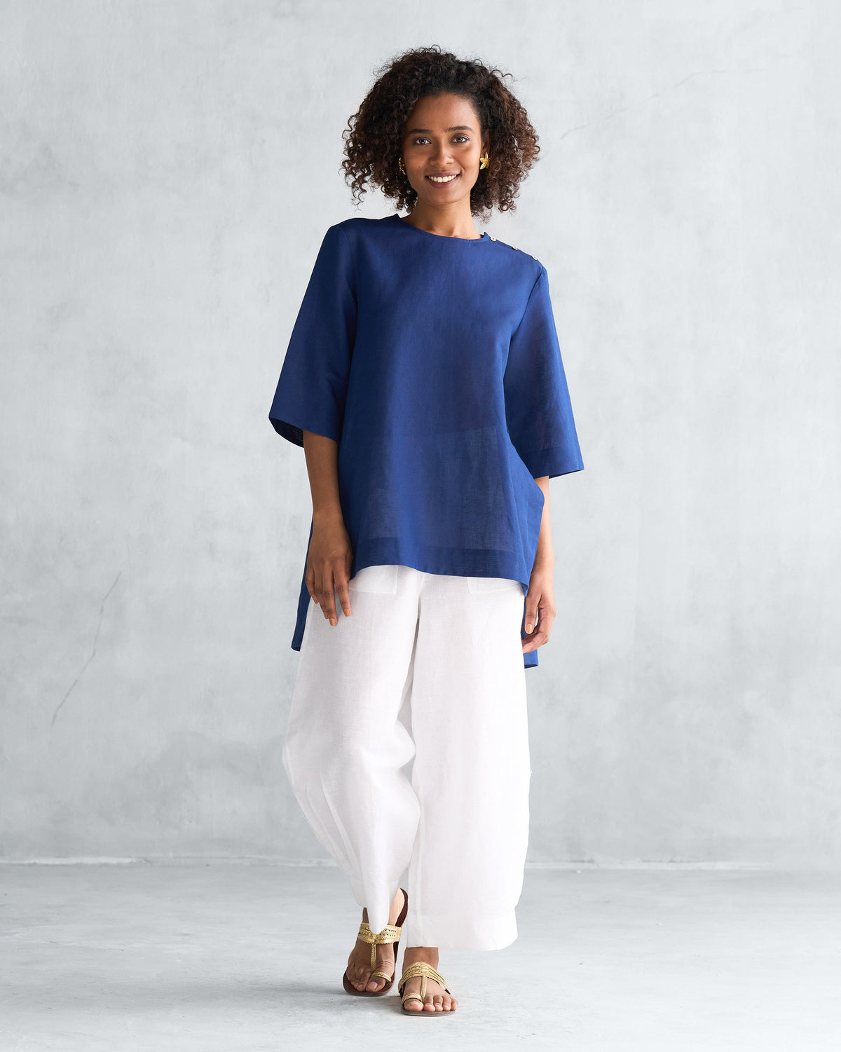 Full-length view of a navy High slit top worn by a person.
