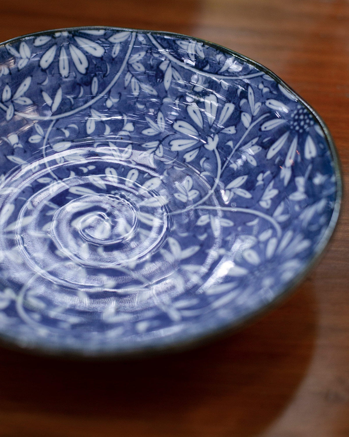 Close-up of the Aika Dessert Bowl's blue floral interior.