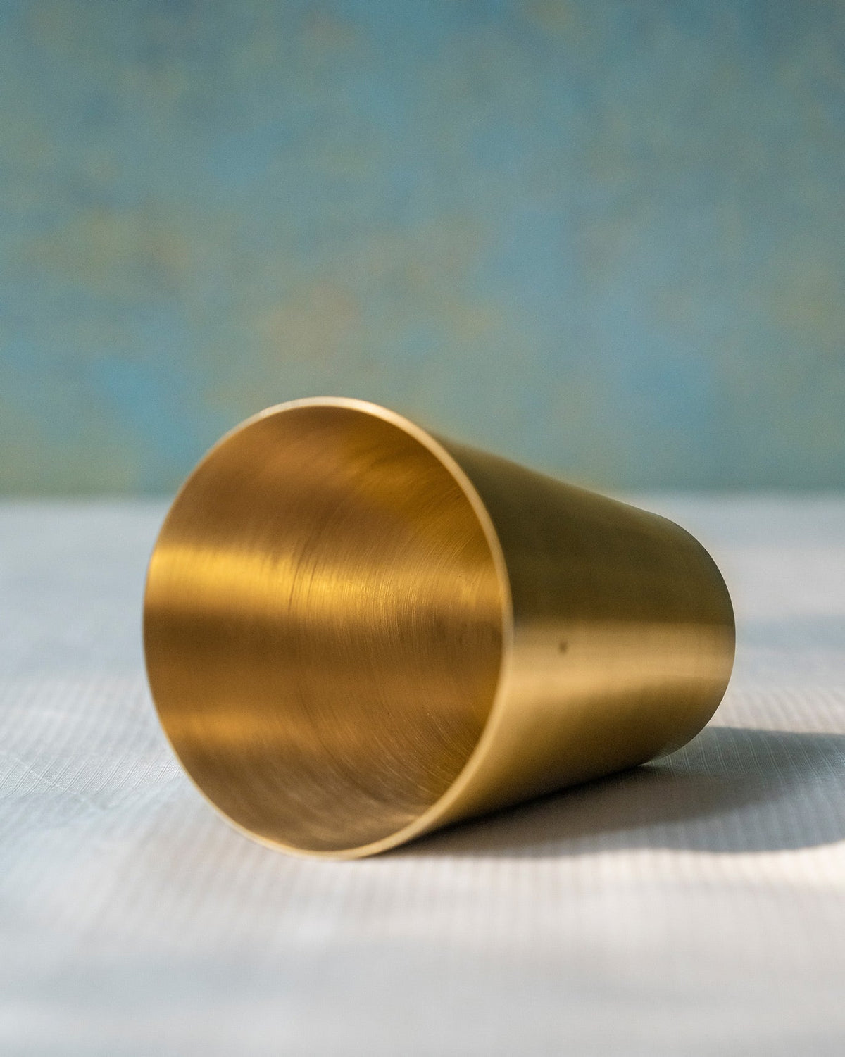 Close-up of a brushed brass tumbler from the Heritage Churn Set.