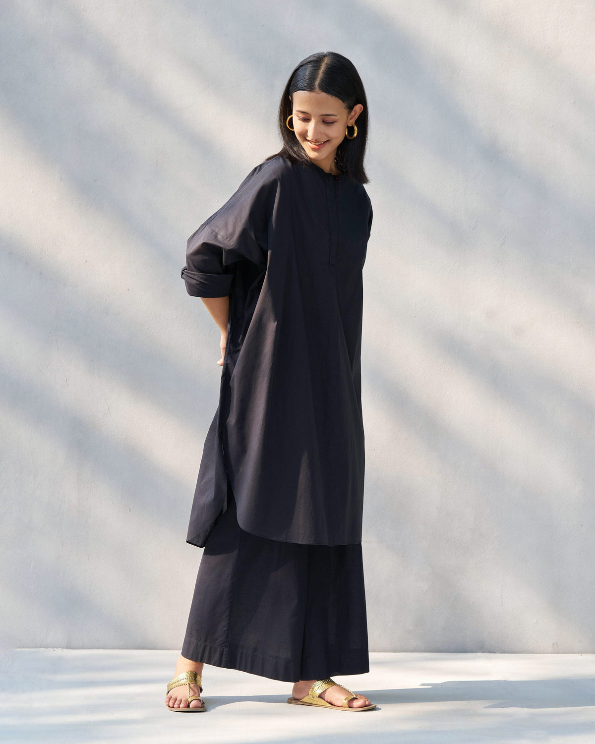 Person wearing the Eclipse set in black, a long top with wide-leg pants.