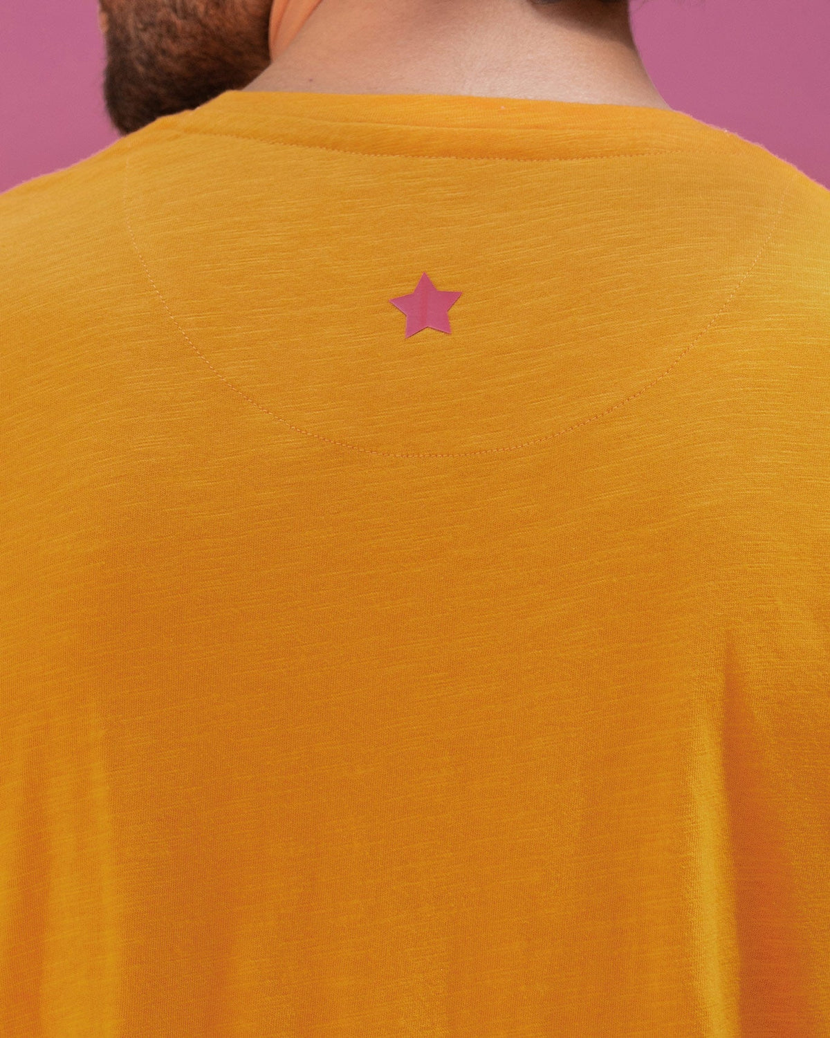 Close-up of the King's Queen T-shirt's back showing a small pink star embroidery.