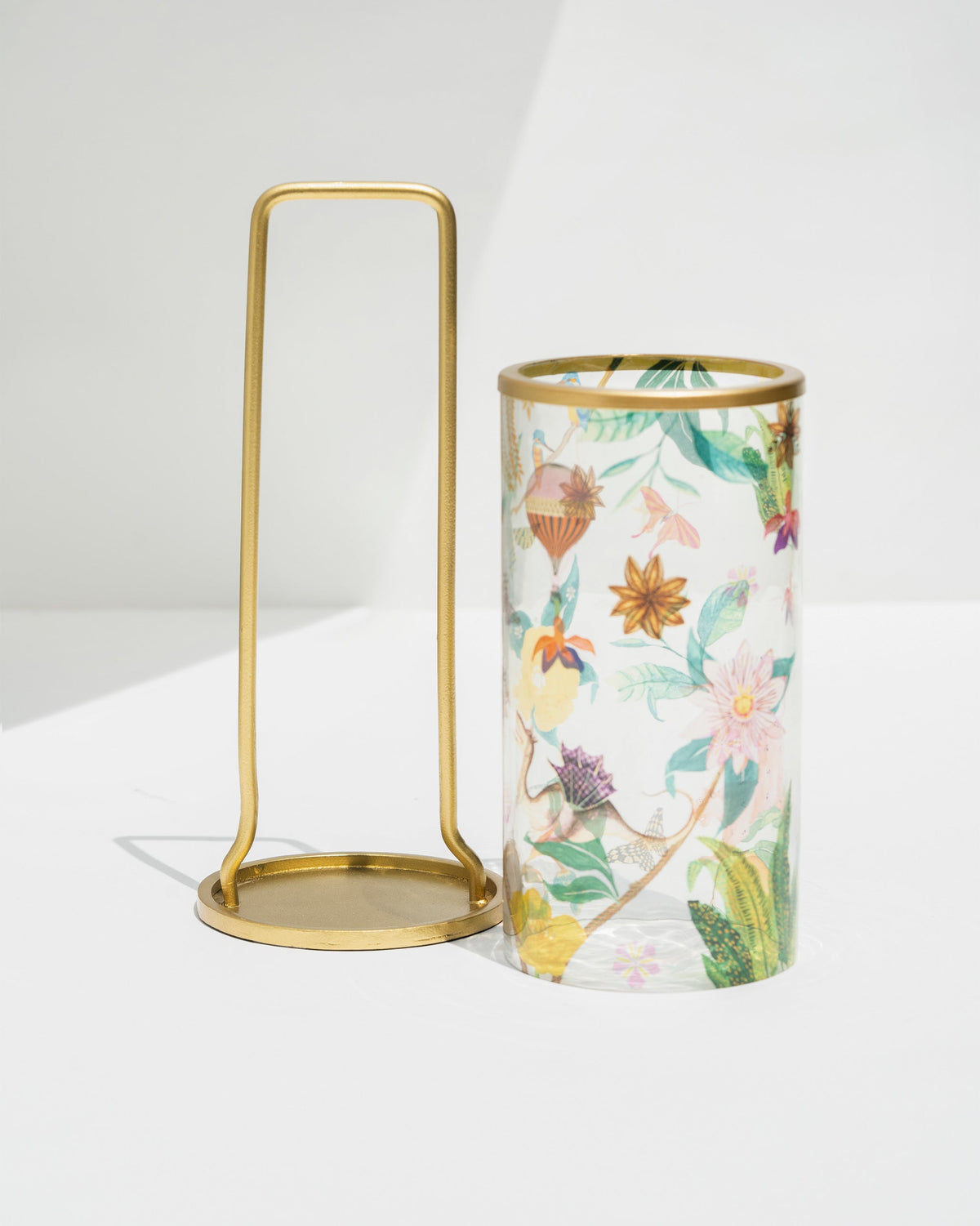 Gold frame and floral-print glass sleeve of the Wildflower lantern, shown separately.