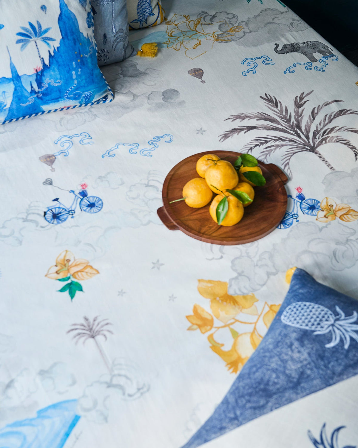 King Bagan Bed Cover on a bed, with a palm and hibiscus print.