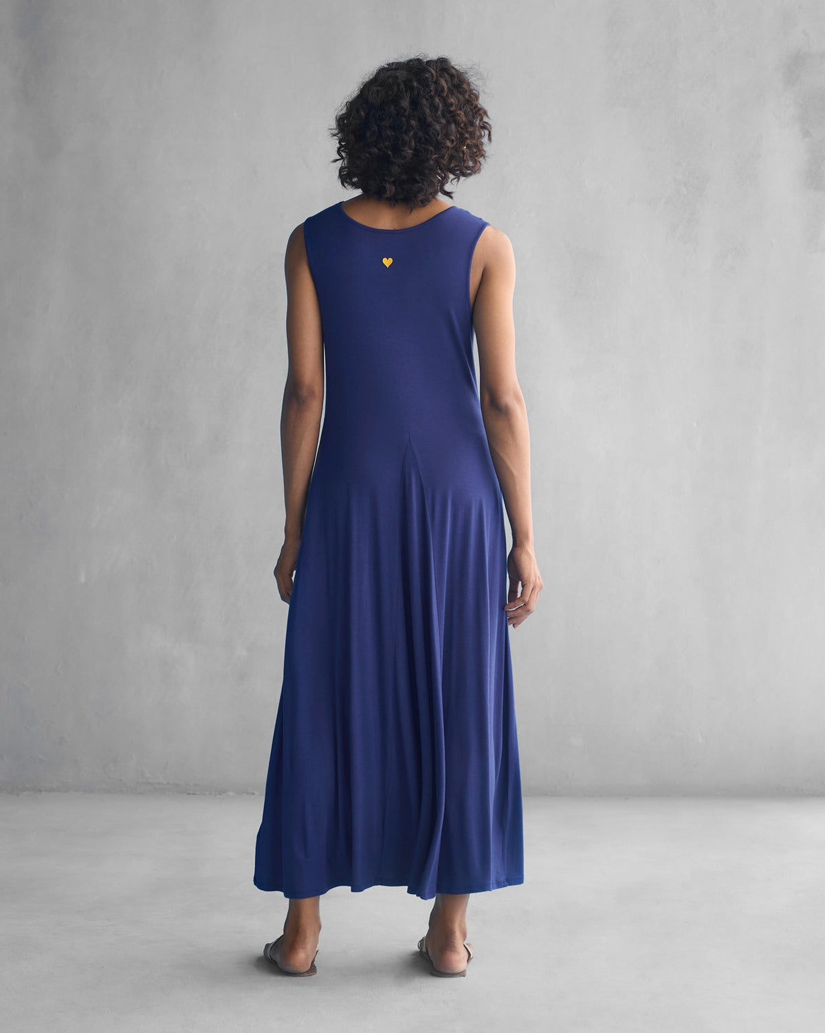 Back of a navy Knotted Knit Dress worn by a person.