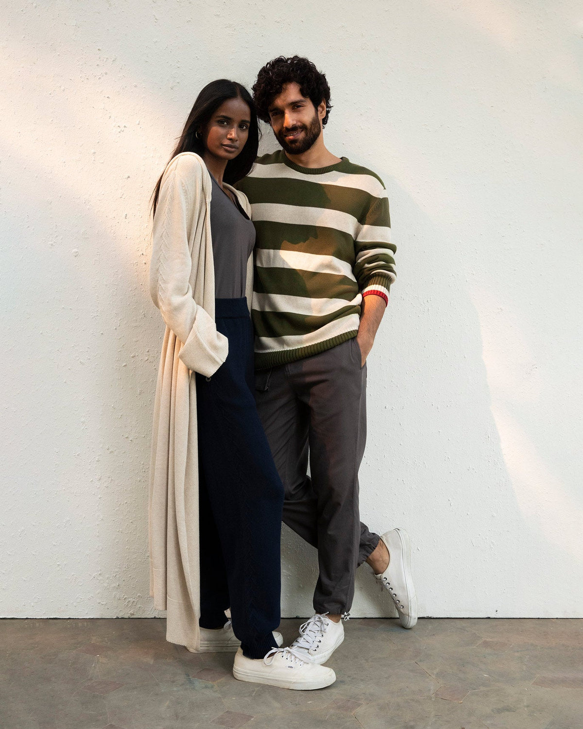 Person wearing an olive and oatmeal Round Neck Sweater beside another person.