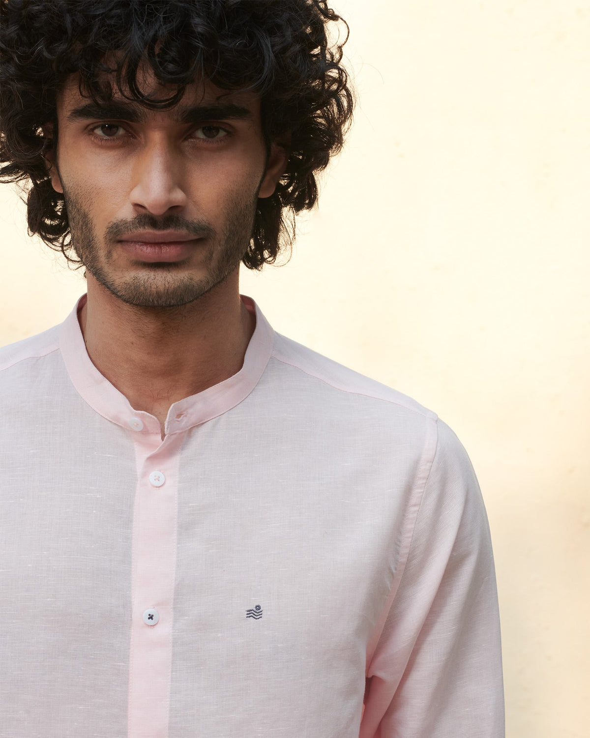 Close-up of a pink Nawab shirt showing the band collar and buttons.