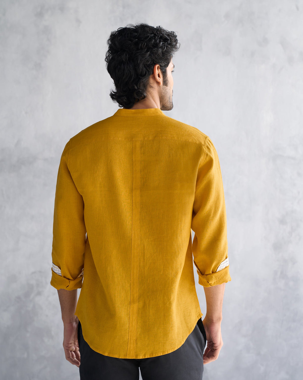 Back of an ochre Nawab shirt worn by a person.