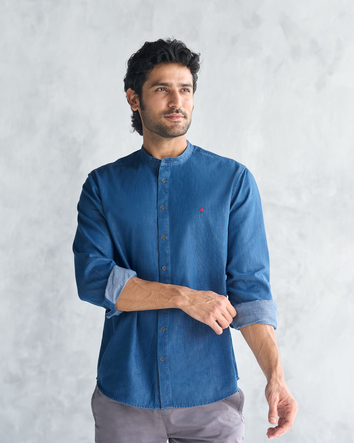 Side view of a blue Nawab Shirt with rolled sleeves and a band collar.
