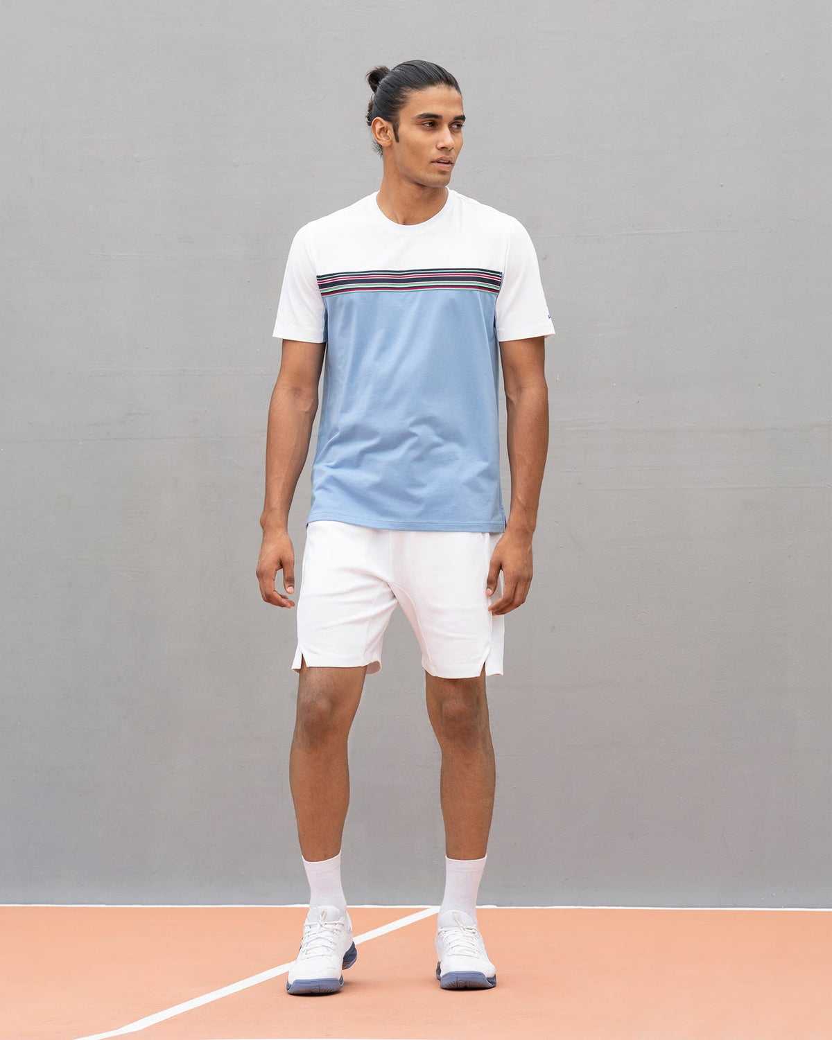 Full-length view of an Everyday Crew Neck T-shirt in white and blue worn by a person.