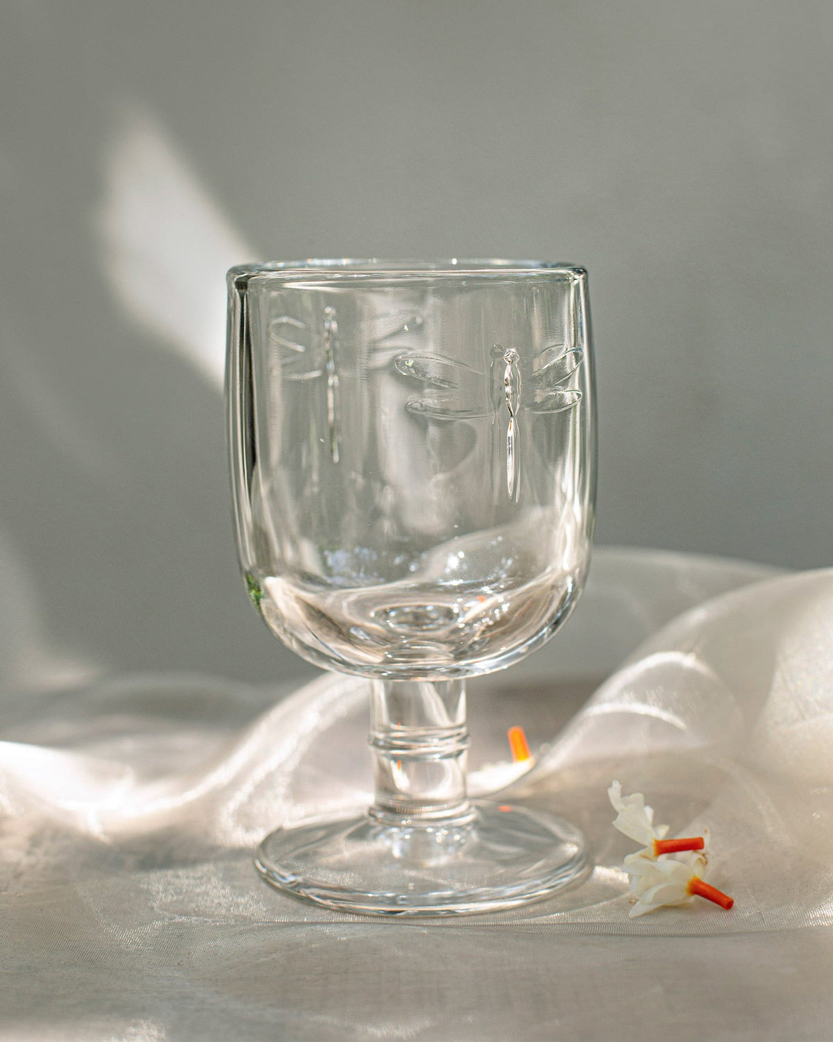 Empty Mahi White Wine Glass showing the dragonfly motif on its bowl.