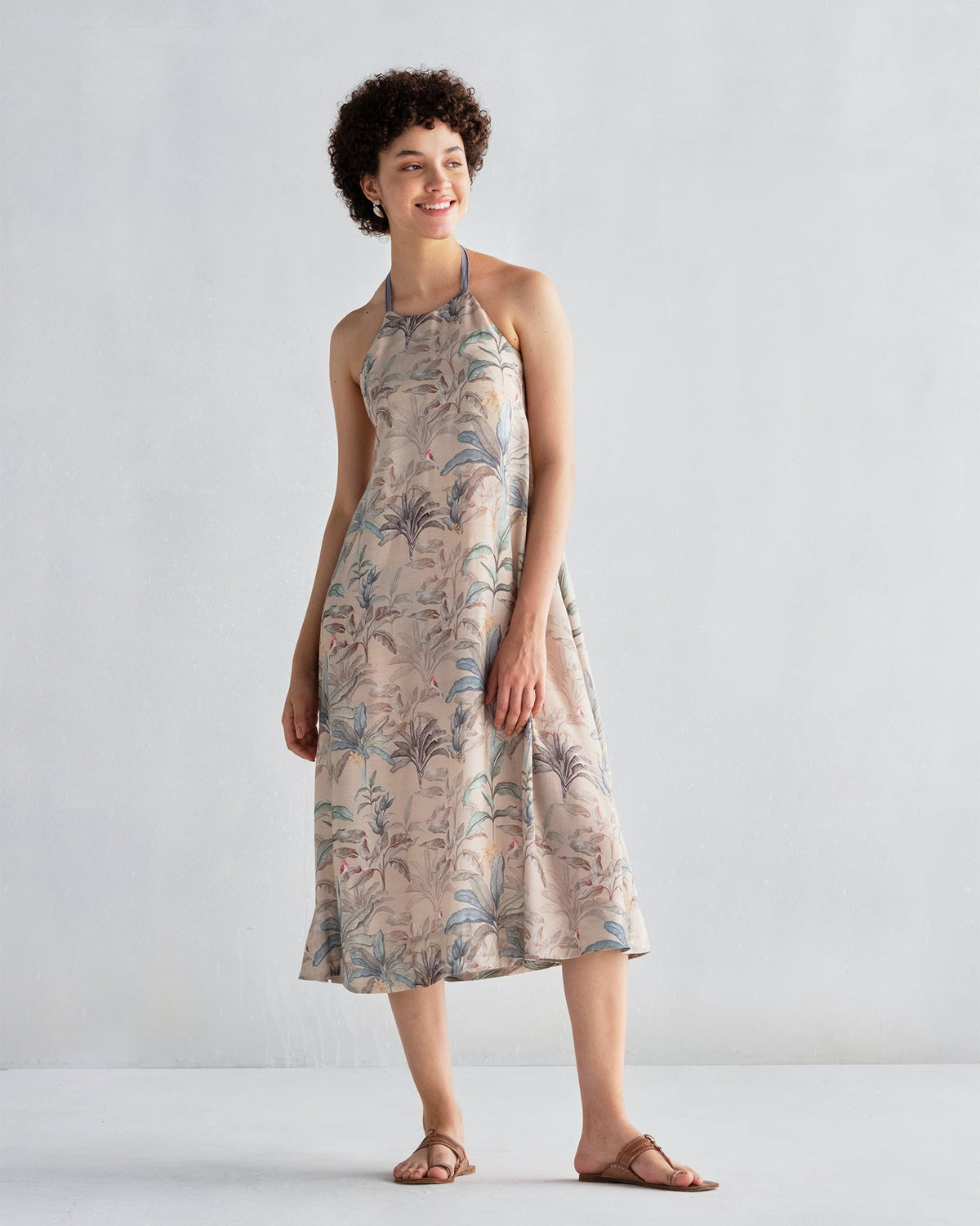 Person wearing Safar Dress in a beige foliage print with a midi length.