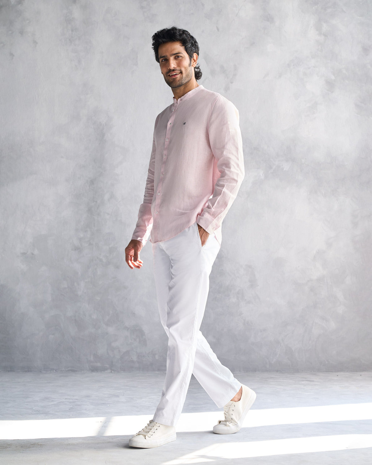 Person wearing a pink Nawab Shirt with a band collar, shown full length.