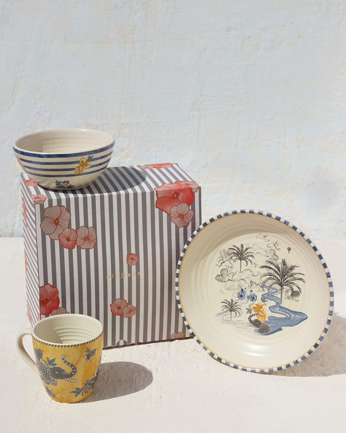Brook Breakfast Set with a striped bowl, painted plate and yellow mug beside a gift box.