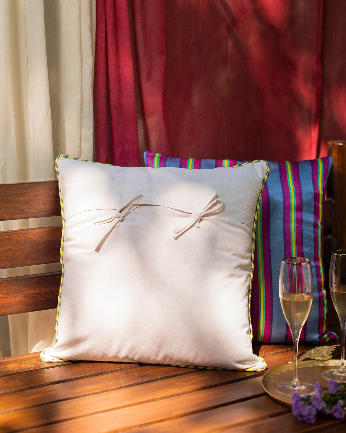 Back of Botanical Cushion Cover showing a plain cream reverse with two bow ties.