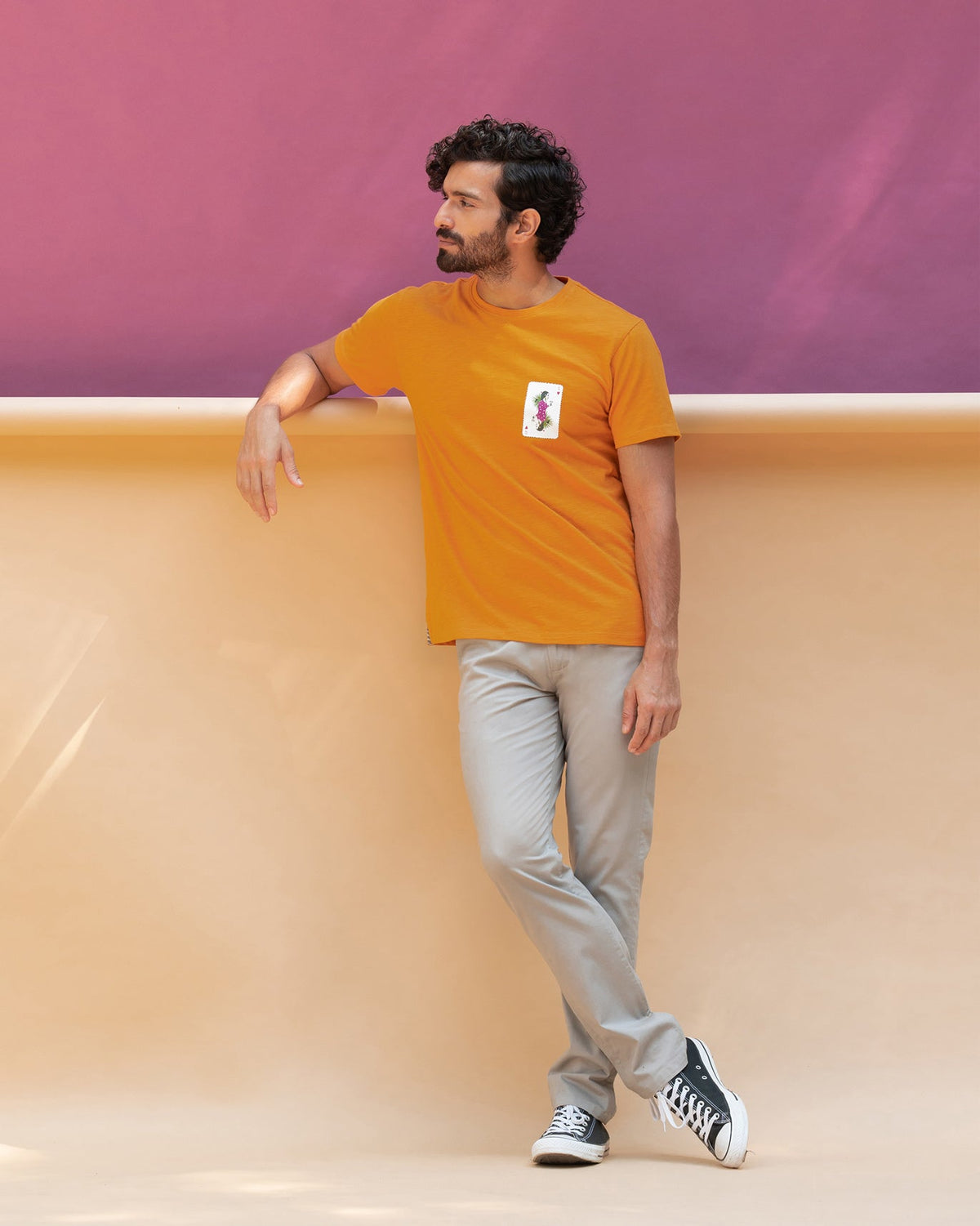 Full-length view of the King's Queen T-shirt with a playing card motif on the chest.