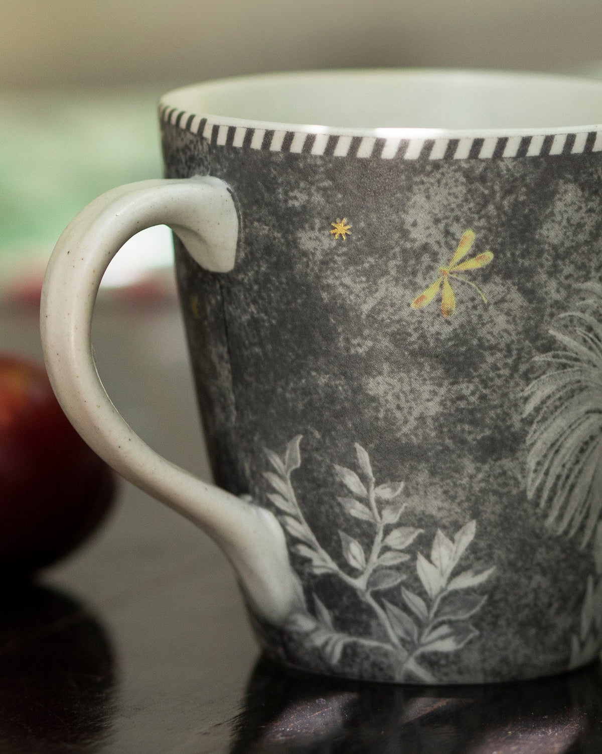 Close-up of Periyar Mug Charcoal showing its handle and leaf motif.
