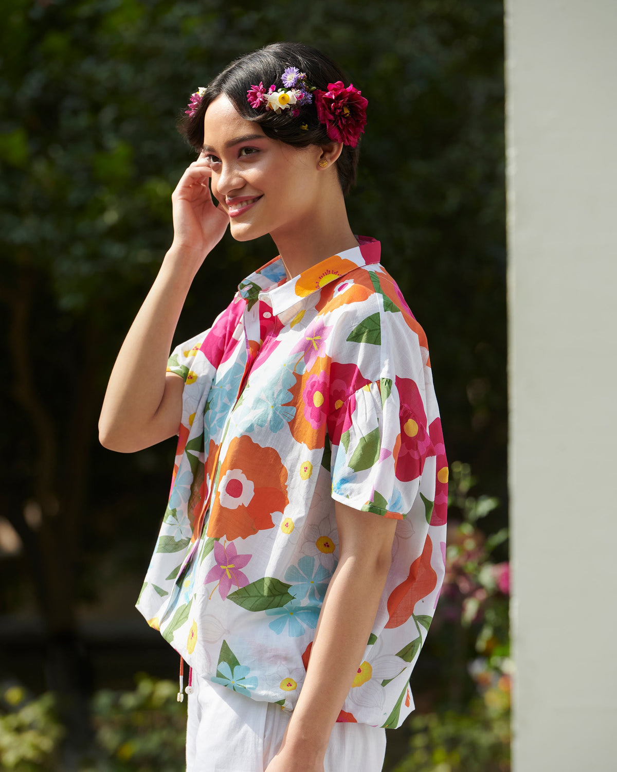 Side view of a white Cord Shirt with bright oversized floral print.