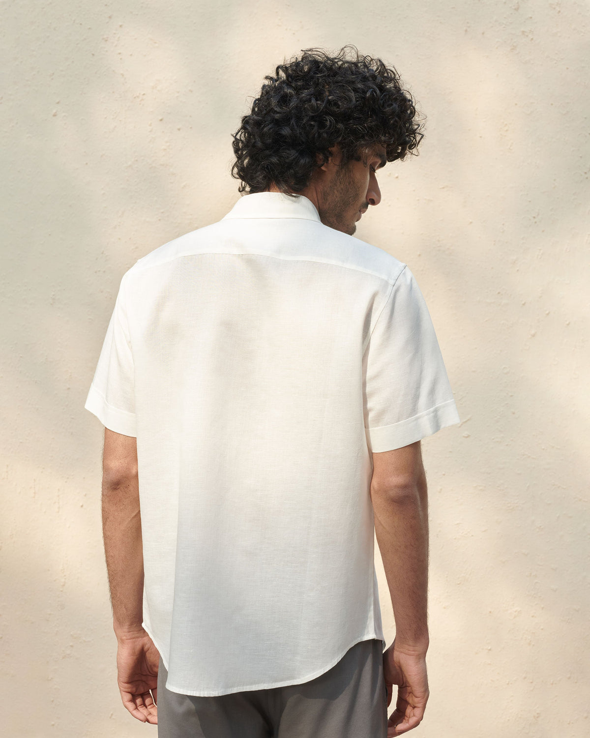 Back of an ivory Half Sleeve Shirt worn by a person.
