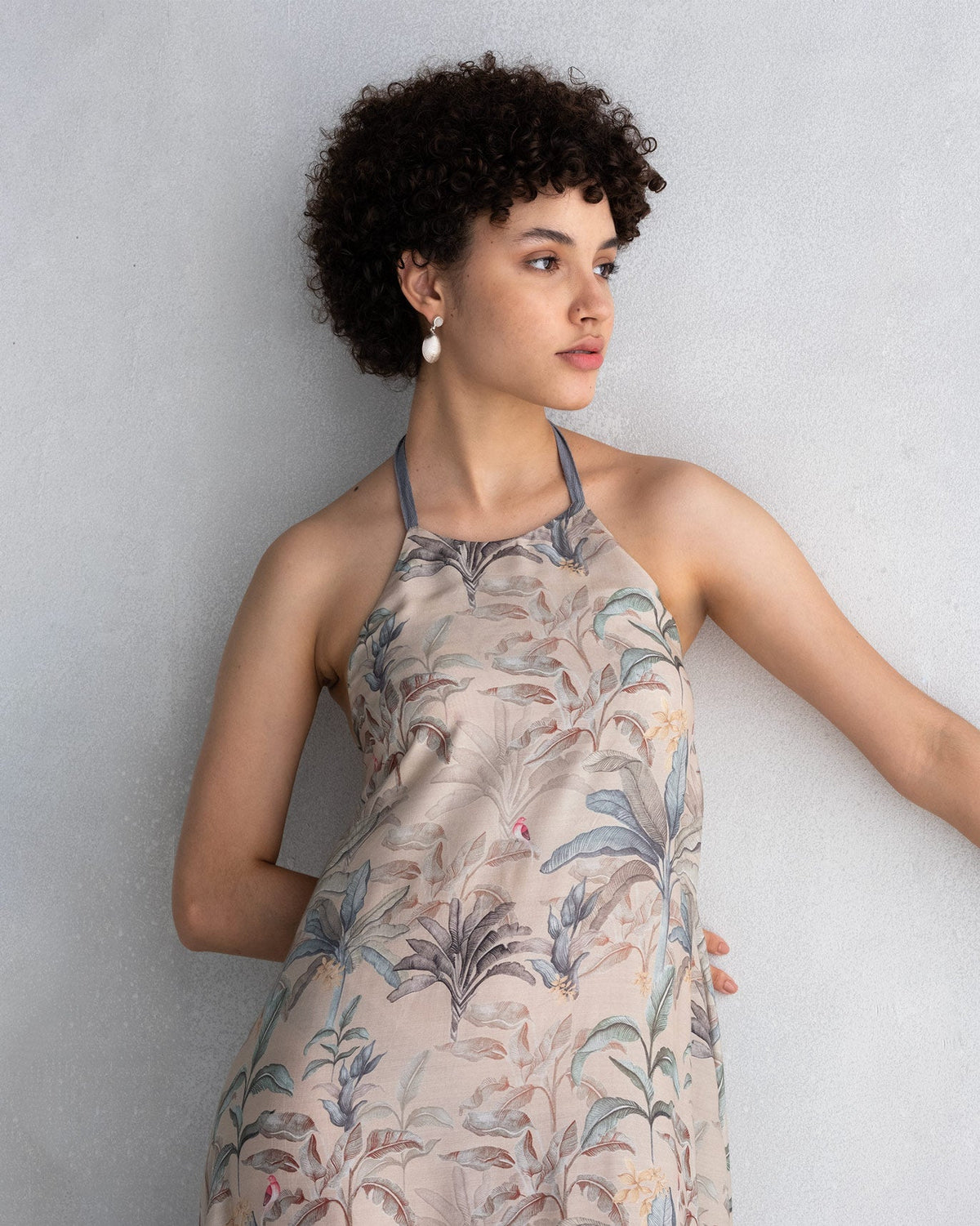 Close-up of Safar Dress bodice and halter neck in a beige foliage print.