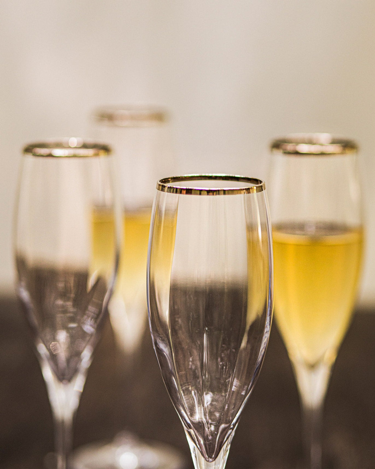 Close-up of Marina Champagne Flute rims showing their gold banding.