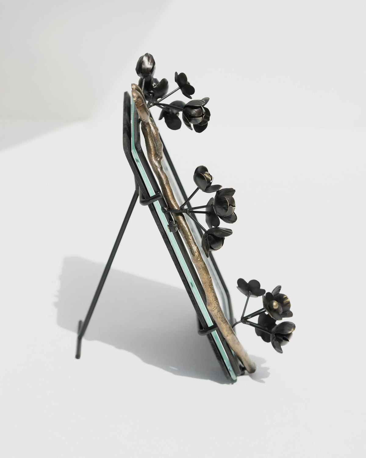 Side view of Wildflower Photo Frame on its slim black stand.