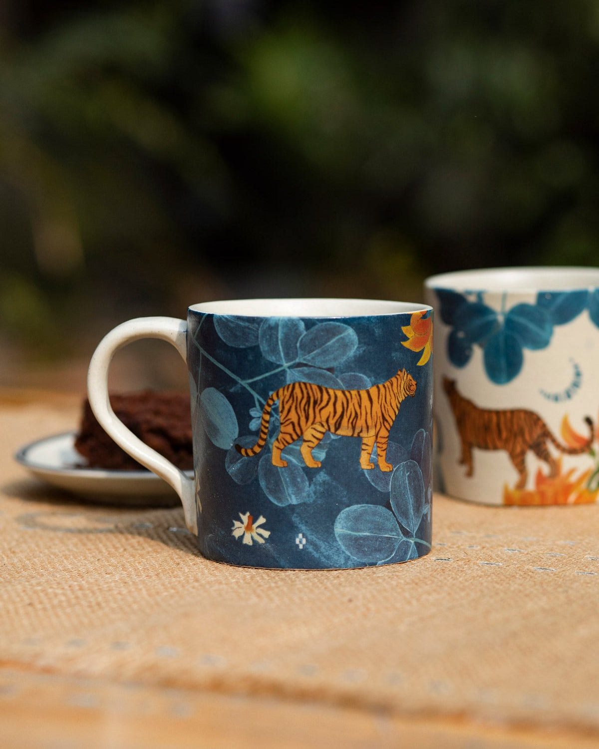 Navy Nadi straight mug with an orange tiger among blue leaves.