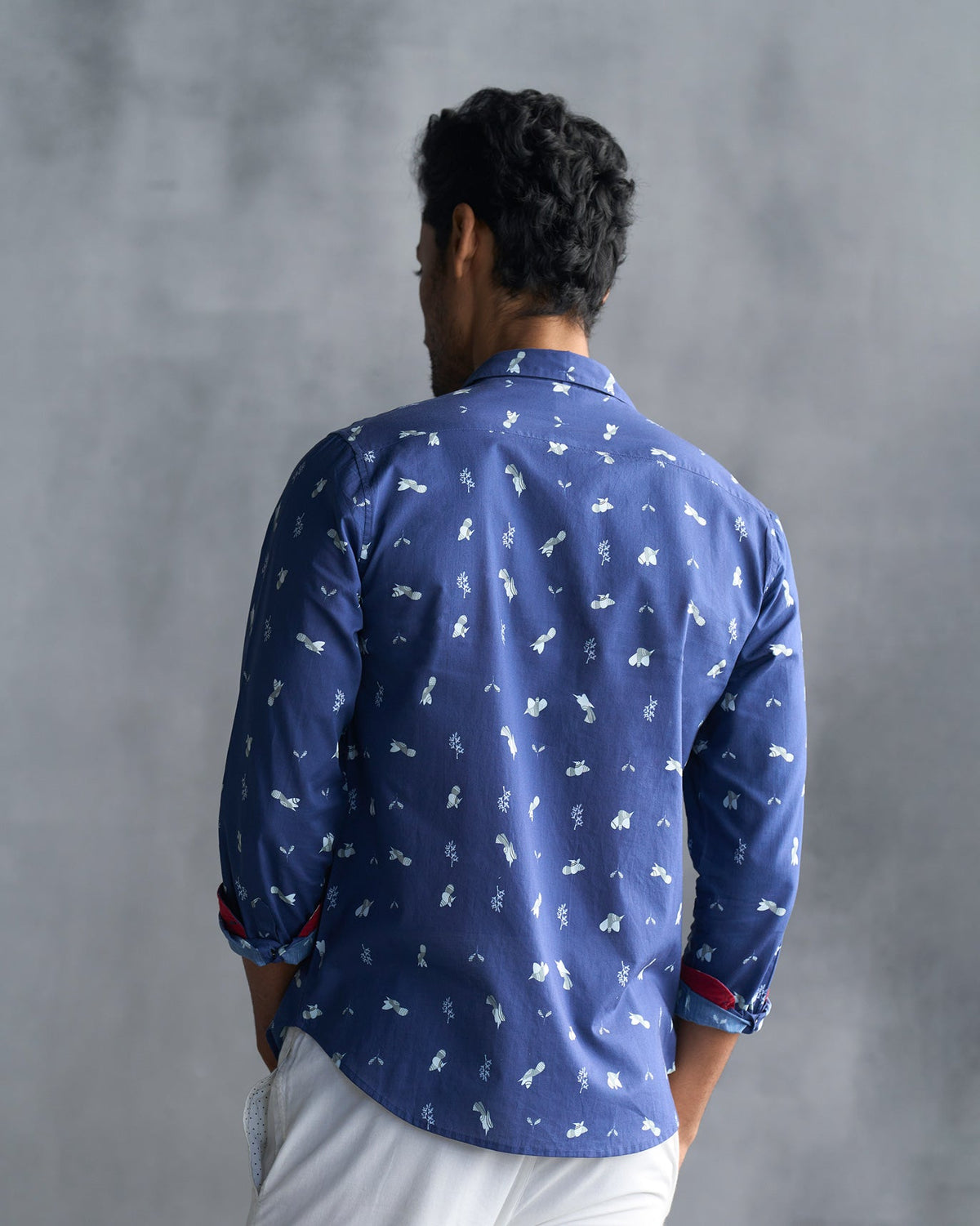 Back of a navy Hakuna Shirt worn by a person.