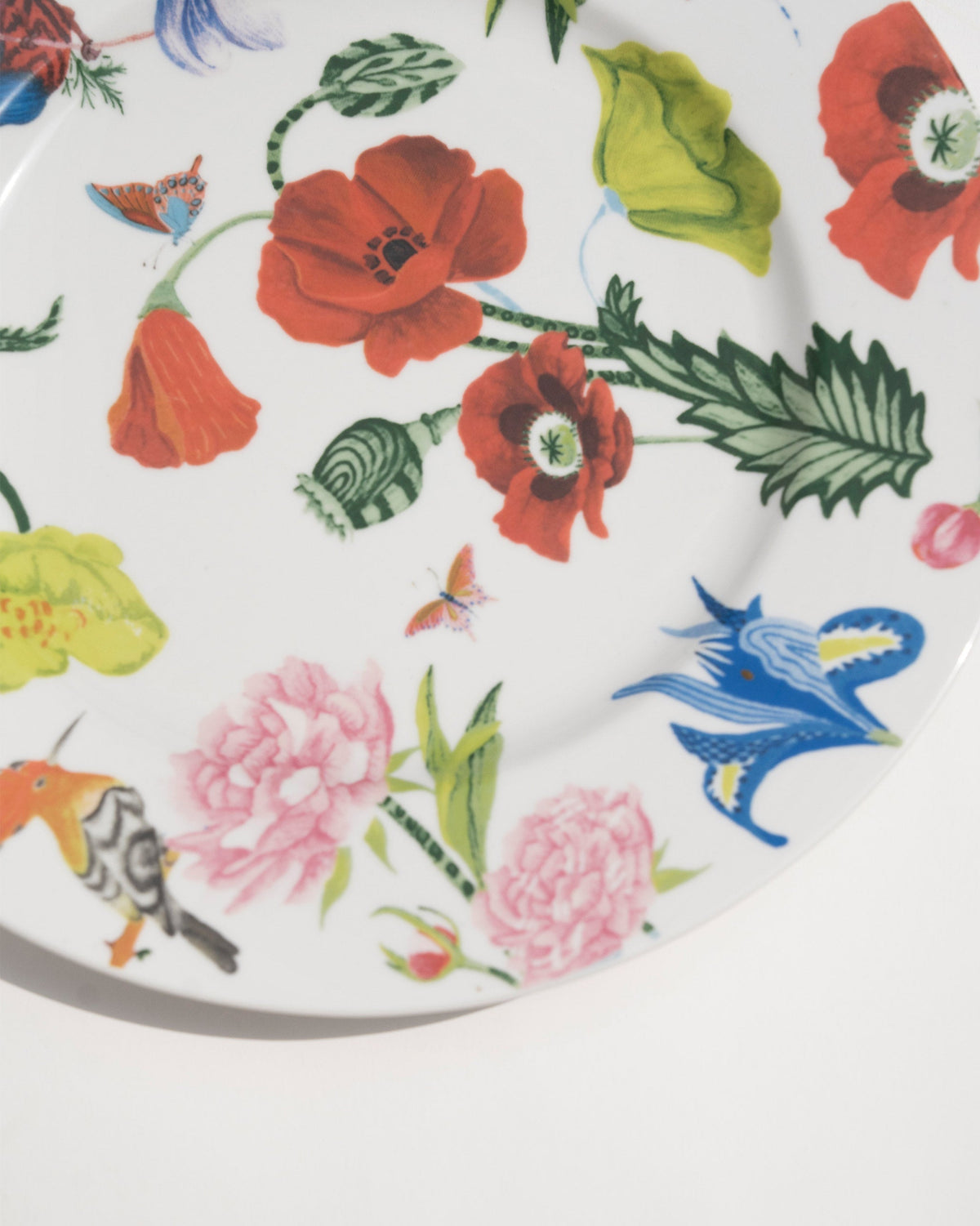 Close-up of the Wildflower Dinner Plate showing poppies and pink blooms on its rim.