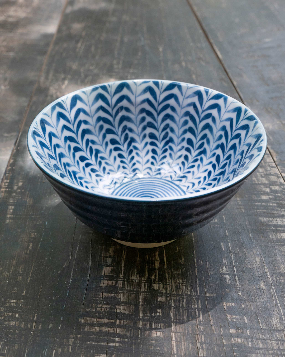 Overhead view of Aiiro Rice Bowl showing its blue chevron and ring pattern inside.