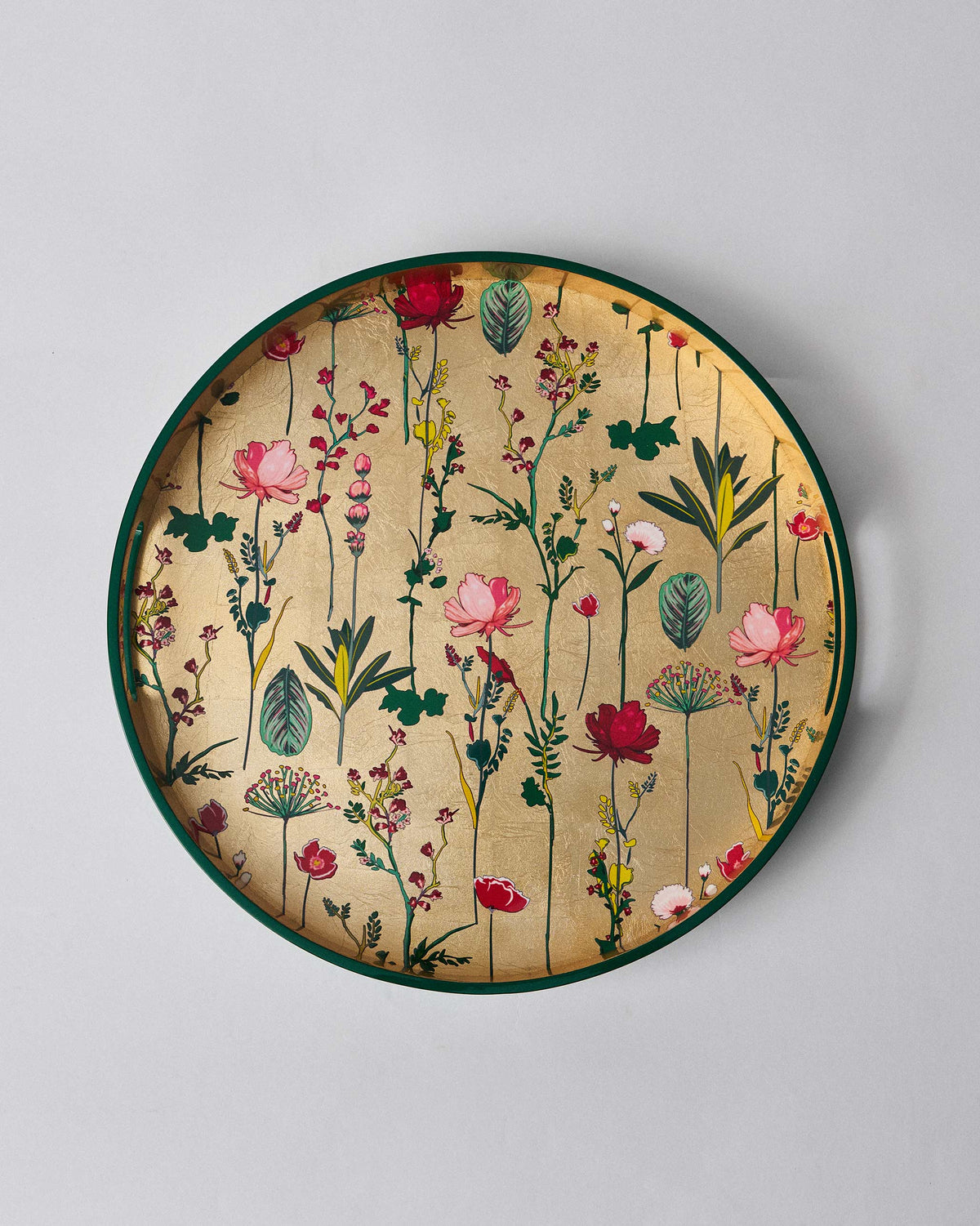 Mahi Round Tray with pink and red flowers on a gold base, viewed from above.