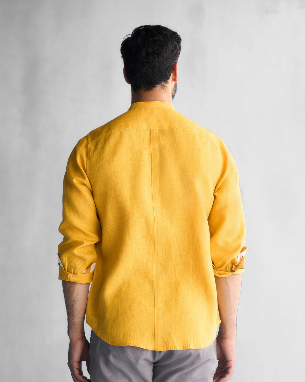 Back of an ochre Nawab shirt worn by a person.