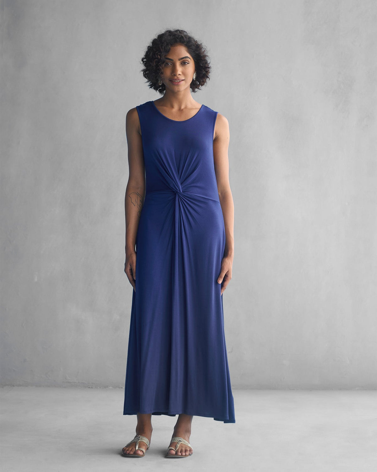 Full-length view of a navy Knotted Knit Dress worn by a person.